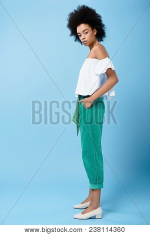 Beautiful Young Woman In Stylish Off-the-shoulder Top On Blue