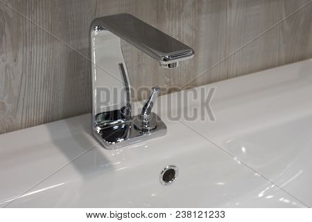 Moderm Metal Shiny Mixer Mounted On White Ceramic Washbasin