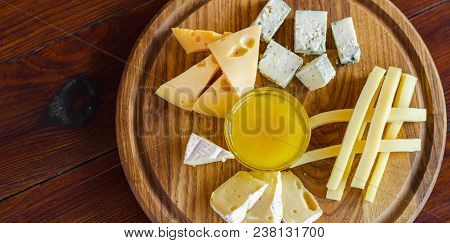 Cheese Plate. Assortment Of Various Types Of Cheese On Wooden Cutting Board.