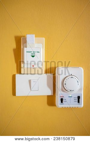 Key-tag, Magnetic Card In Key Box Holder Switch Against Yellow Wall. For Open Electrical In The Room