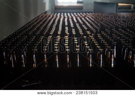 Many Bottles On Conveyor Belt In Glass Factory