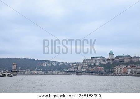 Buda Castle Seen From Pest With The Danube And Szechenyi Chain Bridge In Front.  The Cast Is The His
