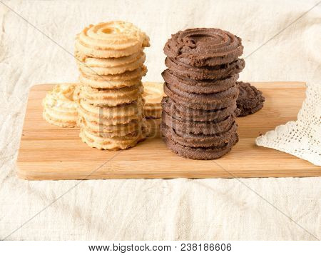 Stacked Homemade Vanilla And Cocoa Cookies On The Wooden Tray