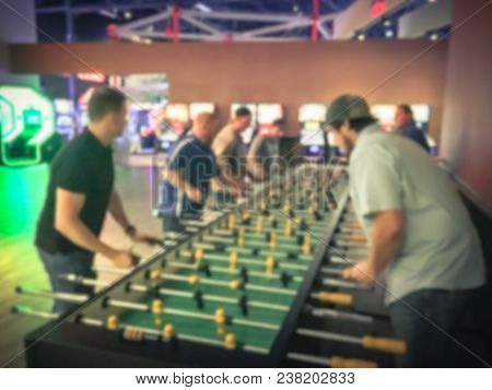 Blurred People Playing Enjoying Foosball Table Soccer Indoor