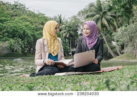 Portrait Of Young Lovely Pleasant Mix Ethnic Woman Sitting On Grass At Summer Green Park And Having 