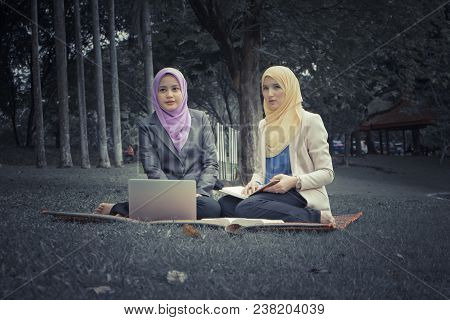 Portrait Of Young Lovely Pleasant Mix Ethnic Woman Sitting On Grass At Summer Green Park And Having 