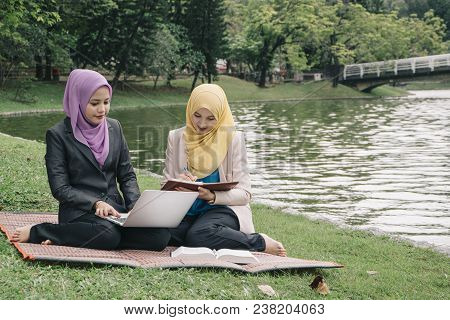 Portrait Of Young Lovely Pleasant Mix Ethnic Woman Sitting On Grass At Summer Green Park And Having 