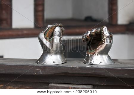 Medieval Armor, Detail Of An Ancient Armor. Steel Gloves On Wooden Background.
