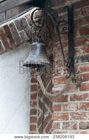 Marine Bell With Braided Rope Close Up On Brick Wall