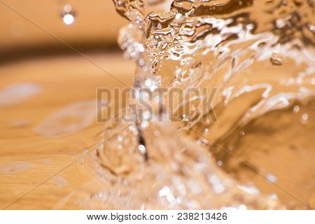 Shining Drop Of Water Colored Of Orange Isolated Composition