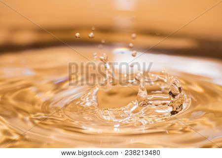 Shining Drop Of Water Colored Of Orange Isolated Composition