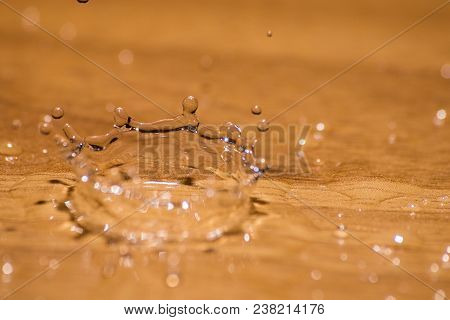 Shining Drop Of Water Colored Of Orange Isolated Composition