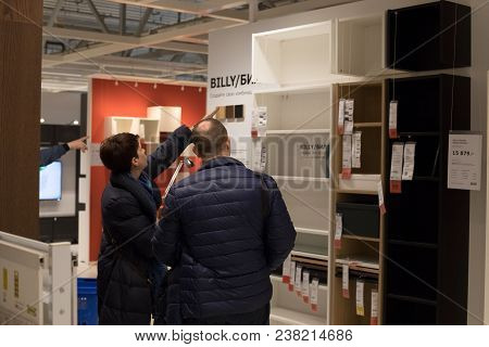 Moscow, Russia - March 25, 2018: Woman And Man Choose Liked Modern Furniture Cabinet In Famous Store