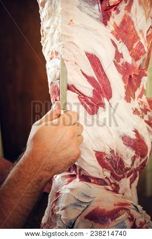 Close Up Image Of A Man Cut Fresh Pork Meat.