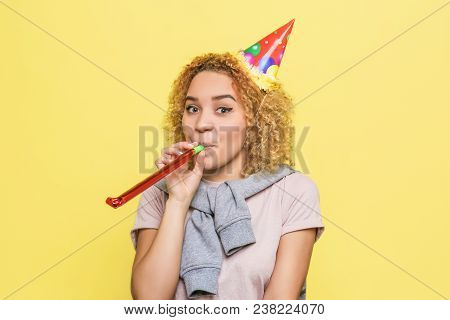 Positive Girl Is Holding A Wistle And Blowing Some Hair Into It. Also She Has A Birthday Hat On Her 