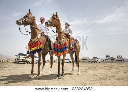 Omani Men On Arabian Horses Decorated For A Race