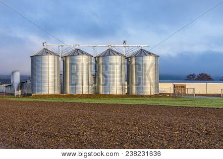 Silo In Beautiful Landscape With Dramatical Light Placed In Plouged Acres