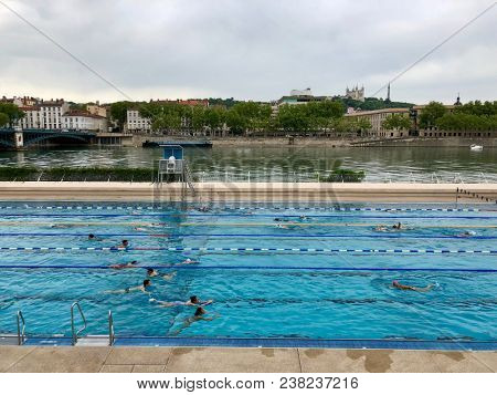 LYON, FRANCE - APRIL 28, 2018: Swimmers at Centre Nautique Tony Bertrand, a riverside public swimming pool next to the river RhÃ´ne, in Lyon, France.