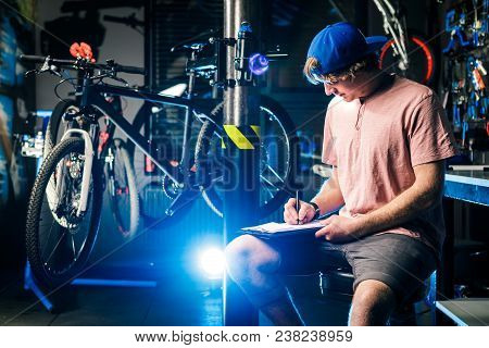 Young Handsome Stylish Man In A Cap Snapback And With A Tattoo Small Business Owner Selling A Bicycl