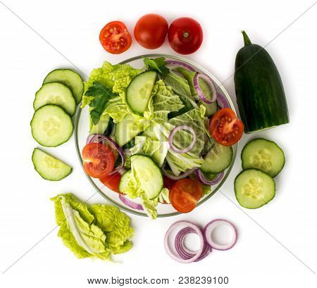 Vegetable Salad In Plate And Ingredients With Which It Is Made On A White Background. The View From 