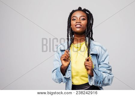 Portrait Of Woman With Hair Braided In Thin Plaits Or Dreadlocks In African Style Isolated On Gray B