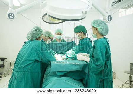 The Surgery Team Working Together At The Operating Room In The Hospital.