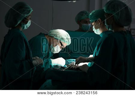 The Surgery Team Working Together At The Operating Room In The Hospital.