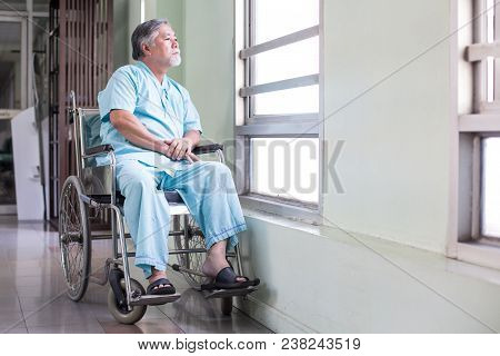 Asian Old Man Sit On Wheelchair Looking Out To Other Place. People With Health Care And Medical Conc