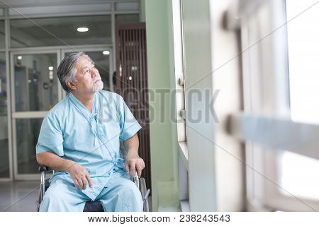 Asian Old Man Sit On Wheelchair Looking Out To Other Place. People With Health Care And Medical Conc