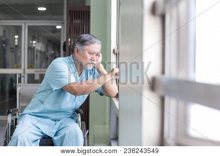 Asian Old Man Sit On Wheelchair Looking Out To Other Place. People With Health Care And Medical Conc