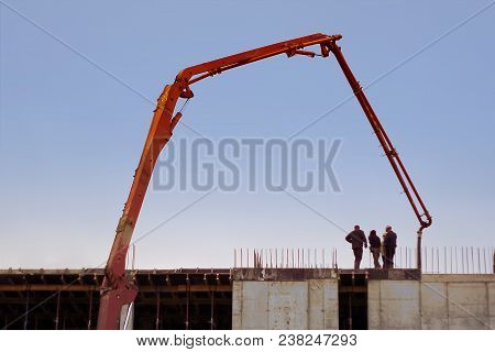 Construction Engineers Supervising Progress Of Construction Project Stand On New Concrete Floor Top 