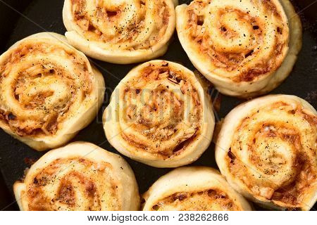 Homemade Pizza Rolls Or Pinwheels Filled With Ham, Onion, Tomato Sauce And Cheese, Photographed Over
