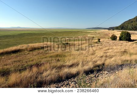 Empty Lake George Nestled Between A Rural Wind Farm And Farmland In Australia. Lake George Is An End