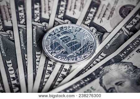 Silver Bitcoin Coin On Us Dollars Close Up