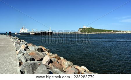 Stockton, Australia - Apr 1, 2018. Big Tanker Is Arriving To The Port. Nobbys Lighthouse In The Back