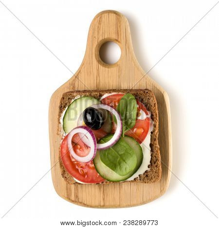 Open  faced vegetable sandwich canape or crostini on a wooden serving board  isolated on white background closeup. Top view.  Vegetarian tartarine.