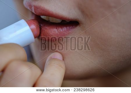 Woman Beauty ,lips Protection With Lipstick Makeup Mouth By Oneself ,selective Focus