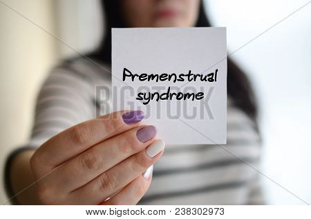 Young Sad Girl Shows A White Sticker. Caucasian Brunette Holding A Sheet Of Paper With Message. Prem