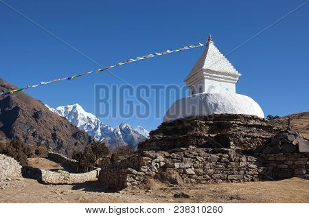 Buddhist White Stupa With Prayer Flags Near Namche Bazaar On The Way To Everest Base Camp, Khumbu, S