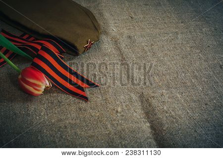 Military Cap With Order Of Great Patriotic War And Tulips Flowers Tied By Saint George Ribbon In Hon