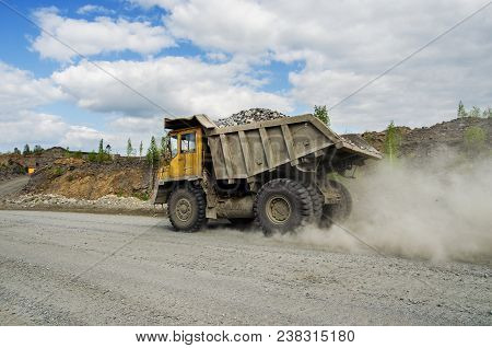 Belaz Truck Transports Ore On A Dirt Road