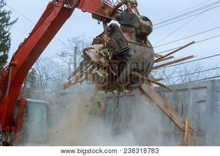 Old House Being Excavator Demolished By A Large Backhoe Wooden Planks And Rubble And The Ruins