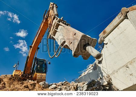 excavator loader machine at demolition with hydrohammer on construction site