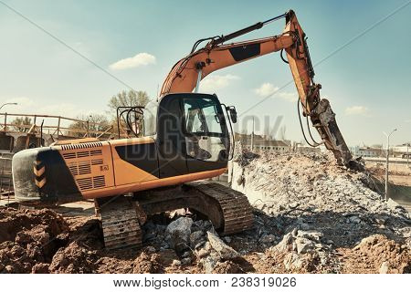 hydraulic breaker hammer excavator at demolition work