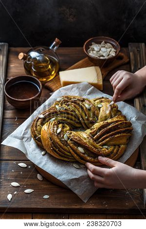 Small Boy Put Pumpkin Seeds On Babka Brioche Wreath.