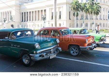 Havana, Cuba - January 16, 2017: A Vintage Car Circulating In Front Of The Capitol In Havana, Cuba. 