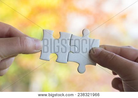 Closeup Hand Of Man Connecting Jigsaw Puzzle With Sunlight Effect, Business Solutions, Success And S
