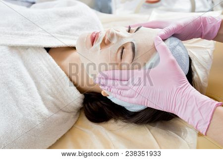 High Angle Portrait Of Pretty Young Woman Lying On Massage Table Enjoying Beauty Treatment With Unre