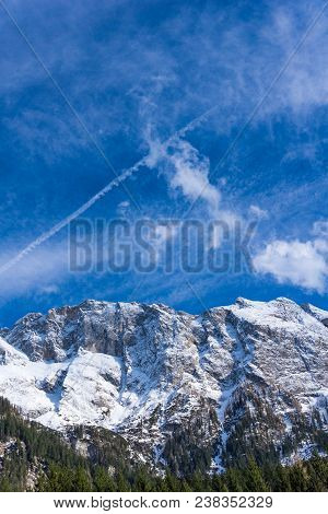 View to the Great snowcapped Mountains of the Bavarian Alps in Germany.
Close-up of the beautiful white Mountains and green Trees of the bavarian Alps on a sunny Day.
Mountain ans Nature Backgrounds.