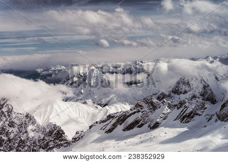 View to the Great snowcapped Mountains of the Bavarian Alps in Germany.
Close-up of the beautiful white Mountains and big white Clouds of the bavarian Alps.
Mountain ans Nature Backgrounds.